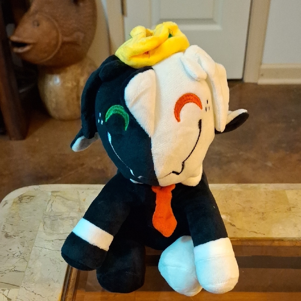 Black and White Plush Toy with Yellow Hat